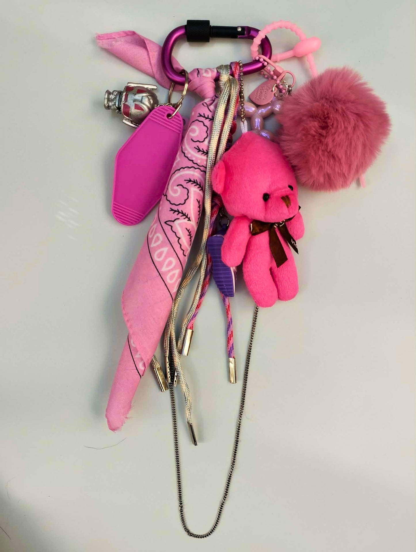 Accessoire de sac Pop et coloré avec pompon rose et pendentifs ludiques, issu de la collection/tribu Pink-Paradise